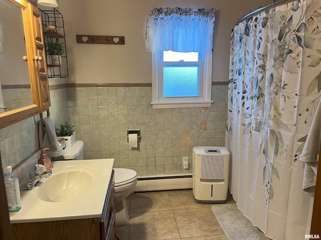 238 E Prairie St, Roodhouse, IL 62082 - bathroom featuring tile walls, vanity, baseboard heating, toilet, and tile patterned floors