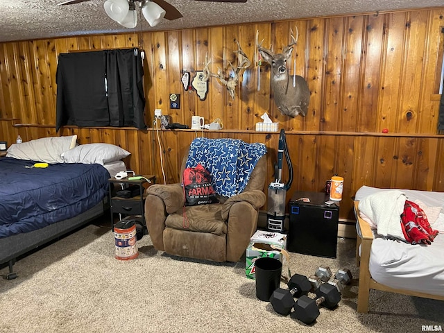 238 E Prairie St, Roodhouse, IL 62082 - bedroom featuring ceiling fan, carpet floors, wooden walls, and a textured ceiling