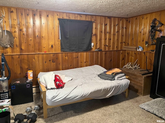 238 E Prairie St, Roodhouse, IL 62082 - bedroom featuring baseboard heating, wooden walls, carpet, and a textured ceiling