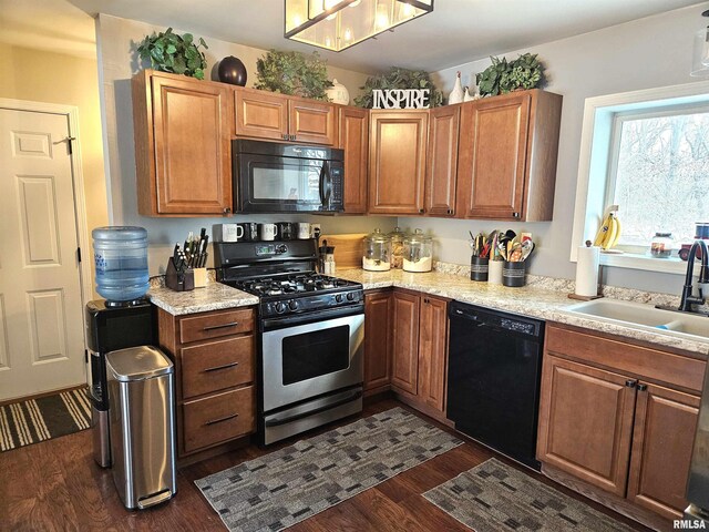 kitchen with sink, dark hardwood / wood-style flooring, and black appliances