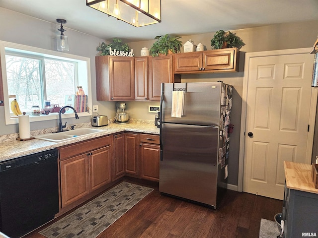 kitchen with sink, stainless steel fridge, dishwasher, light stone countertops, and dark hardwood / wood-style flooring