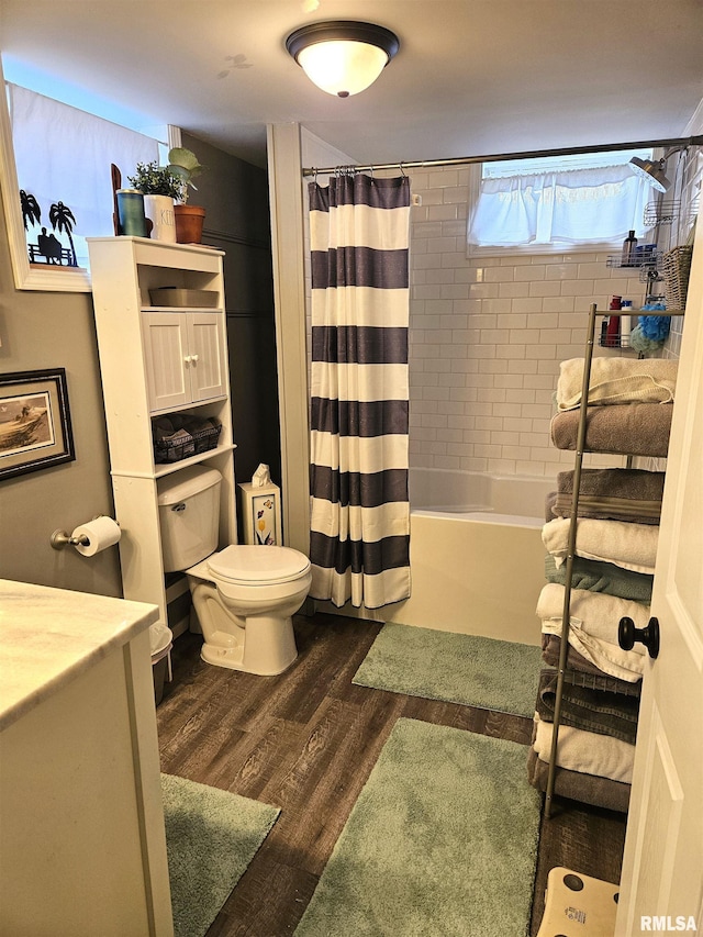 bathroom with wood-type flooring, toilet, and shower / bath combo with shower curtain