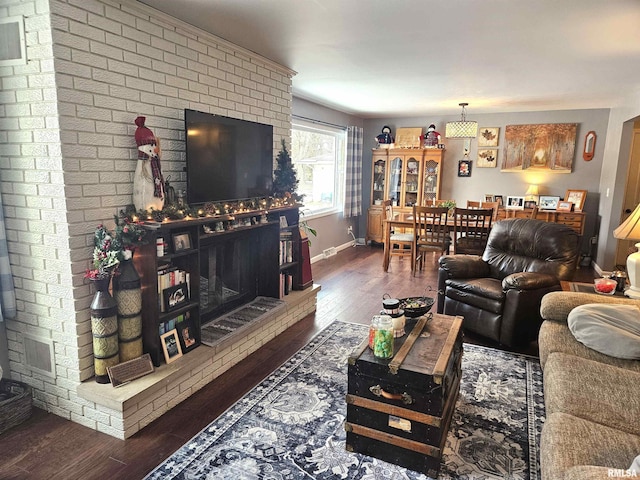 living room with dark hardwood / wood-style floors and a fireplace