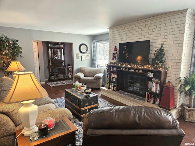 living room featuring dark wood-type flooring and a fireplace