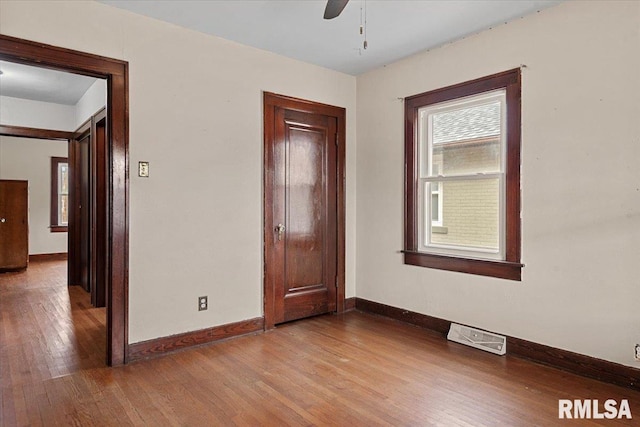 empty room featuring hardwood / wood-style flooring and ceiling fan