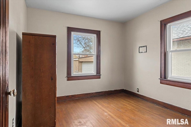 spare room with wood-type flooring