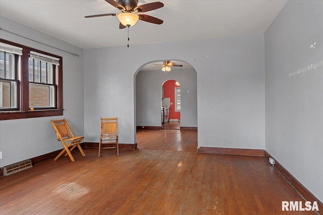 empty room with wood-type flooring and ceiling fan