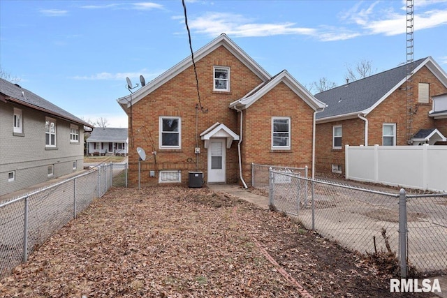 rear view of house with central AC unit