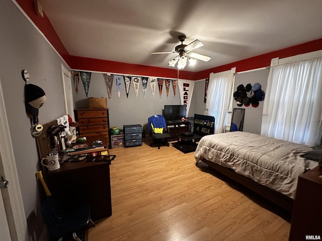 bedroom featuring hardwood / wood-style flooring and ceiling fan