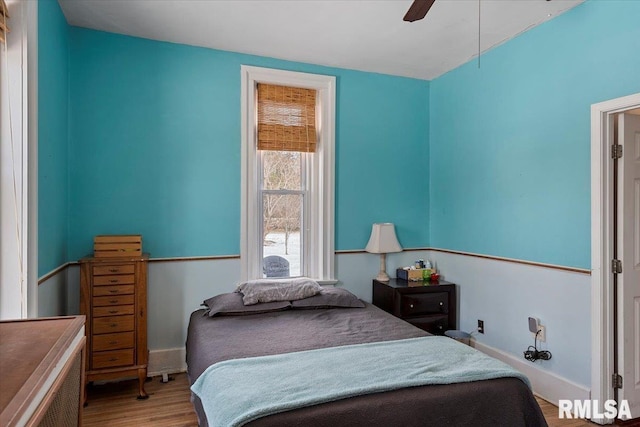 bedroom with wood-type flooring and ceiling fan