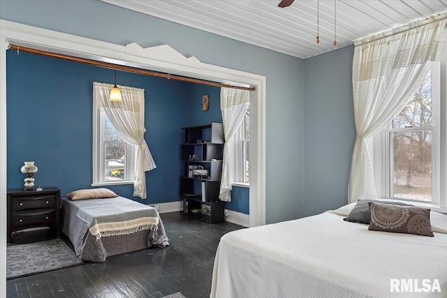 bedroom featuring dark hardwood / wood-style floors and ceiling fan