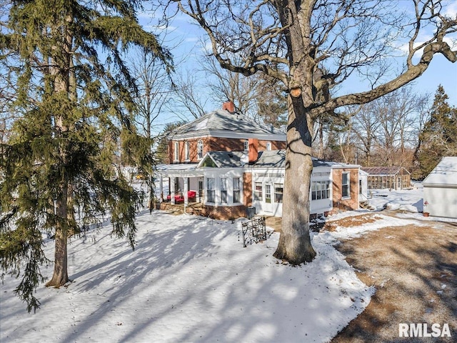 view of snow covered rear of property