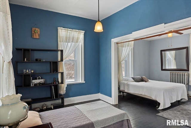 bedroom featuring hardwood / wood-style flooring and radiator heating unit