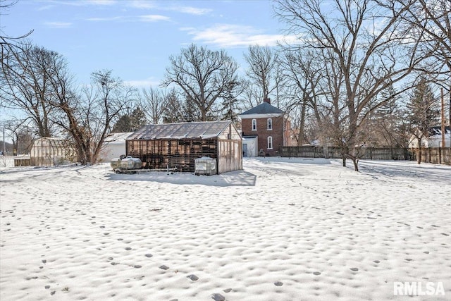 yard layered in snow featuring an outdoor structure