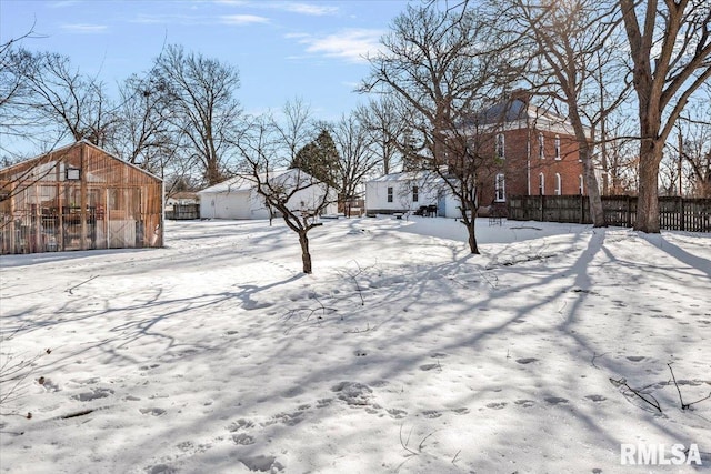 yard covered in snow with an outdoor structure