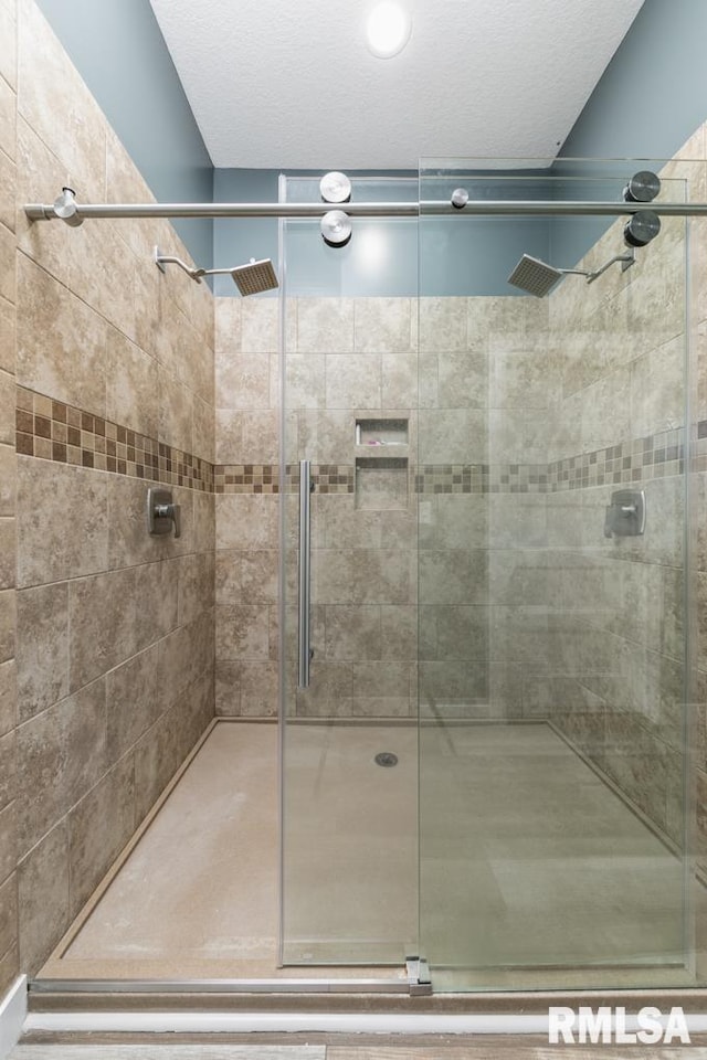 bathroom featuring a shower with shower door