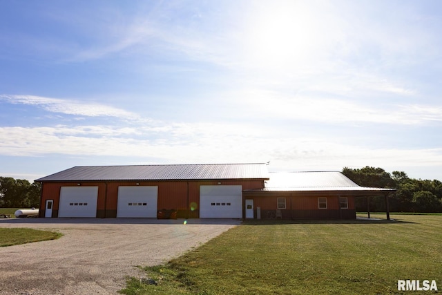 view of outbuilding with a carport and a yard