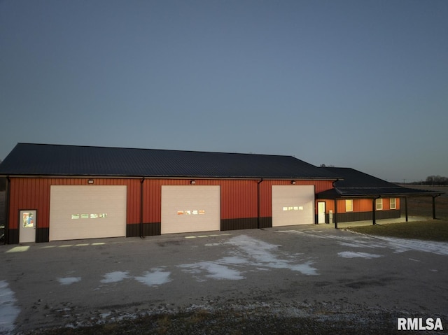 view of garage at dusk