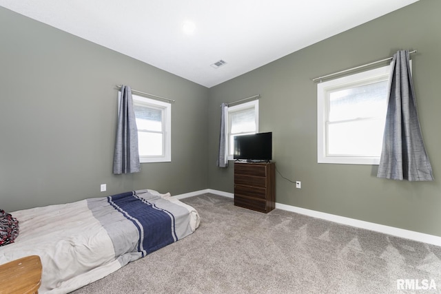 bedroom featuring light carpet