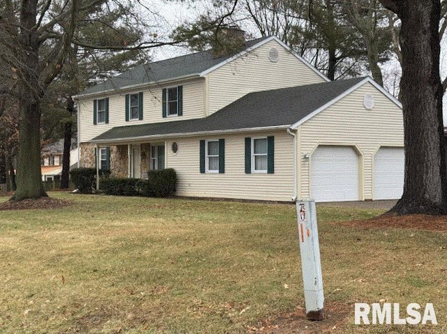 view of front facade with a garage and a front yard