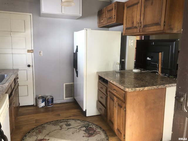 kitchen with dark hardwood / wood-style flooring and white appliances