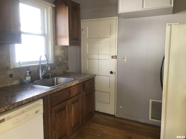 kitchen with refrigerator, dishwasher, sink, backsplash, and dark hardwood / wood-style flooring