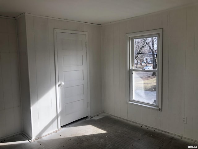 unfurnished room featuring dark parquet floors