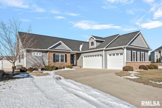 view of front facade featuring a garage and central AC unit