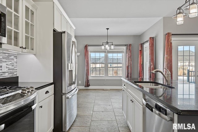 kitchen with white cabinetry, sink, backsplash, and appliances with stainless steel finishes