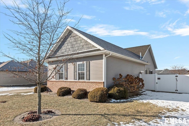 snow covered property featuring a yard