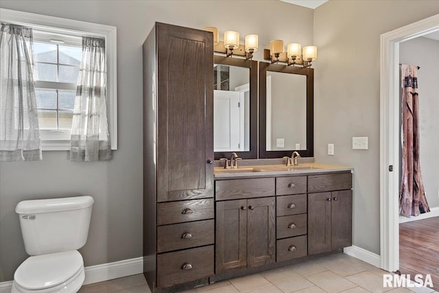 bathroom with vanity, tile patterned floors, and toilet