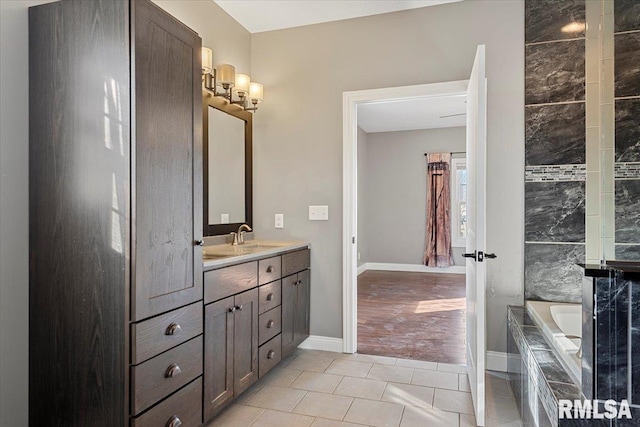 bathroom featuring vanity, tile patterned flooring, and a tub