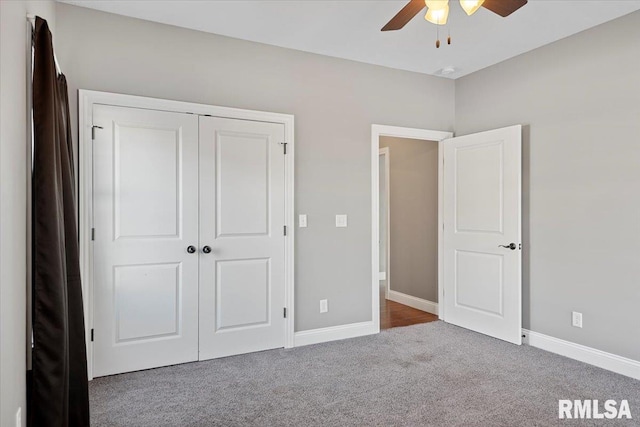 unfurnished bedroom with a closet, ceiling fan, and dark colored carpet