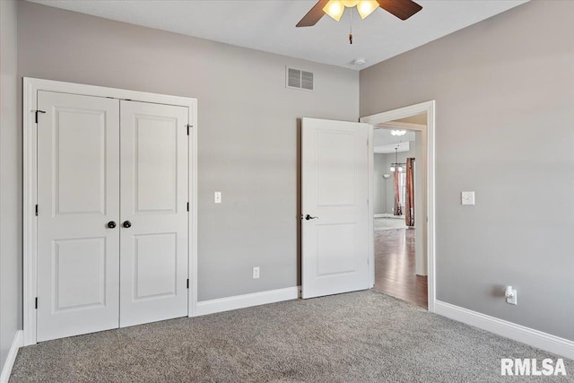 unfurnished bedroom featuring a closet, ceiling fan, and carpet flooring