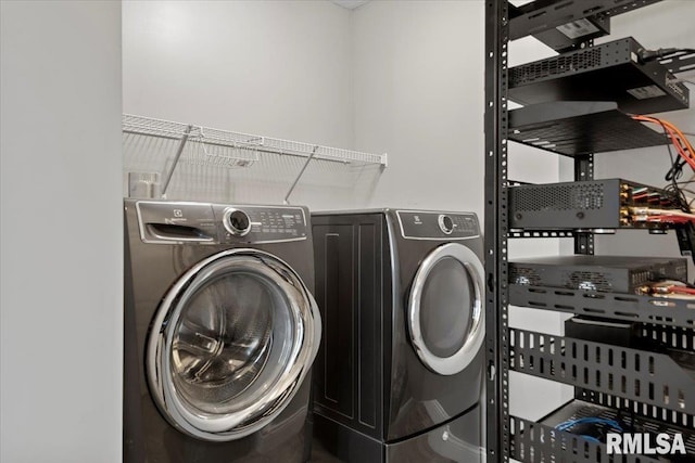 clothes washing area with washing machine and clothes dryer