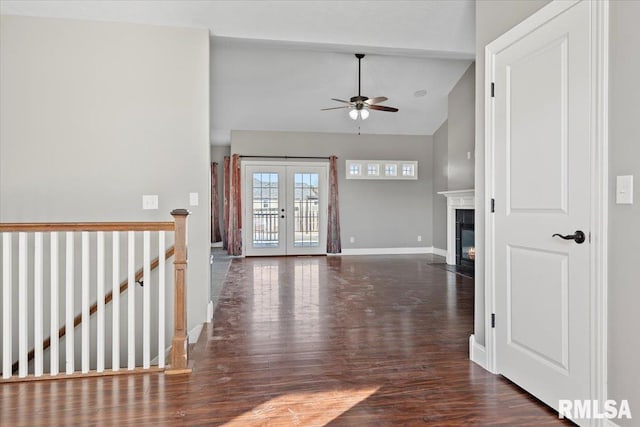 interior space featuring vaulted ceiling with beams, dark wood-type flooring, french doors, and ceiling fan