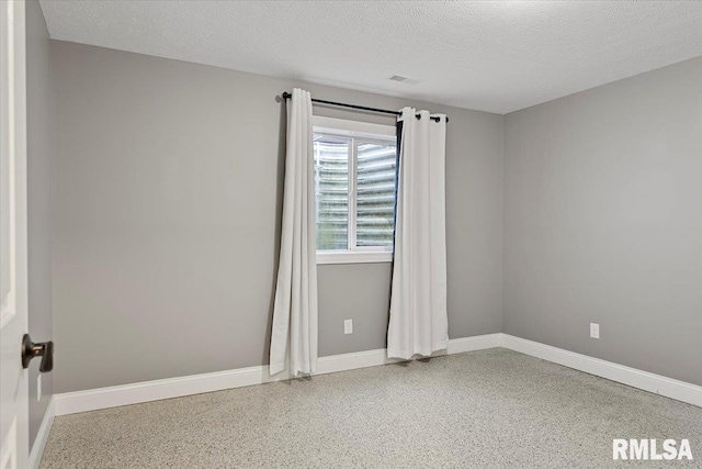 empty room featuring a textured ceiling