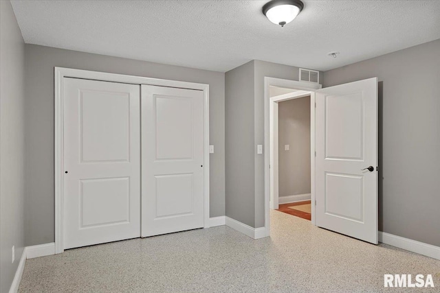 unfurnished bedroom with a closet and a textured ceiling