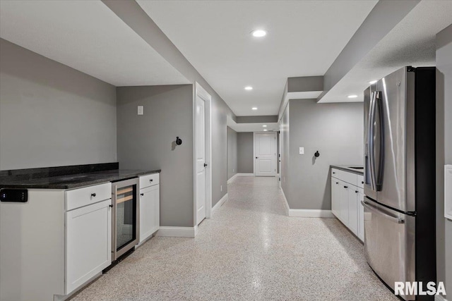 kitchen with white cabinets, beverage cooler, and stainless steel fridge with ice dispenser