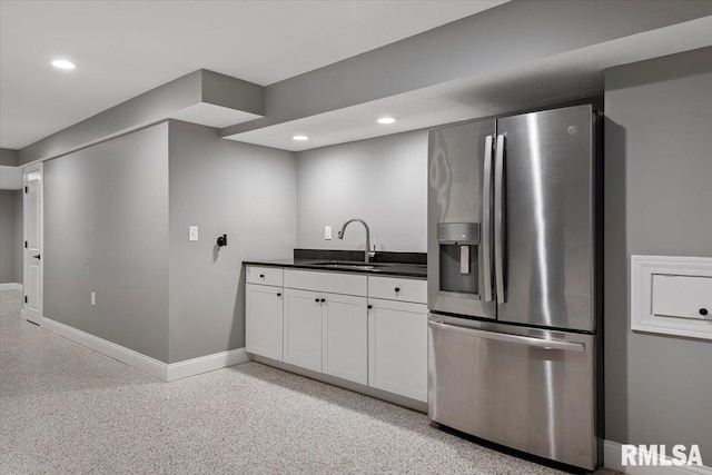 kitchen with white cabinetry, stainless steel fridge with ice dispenser, and sink