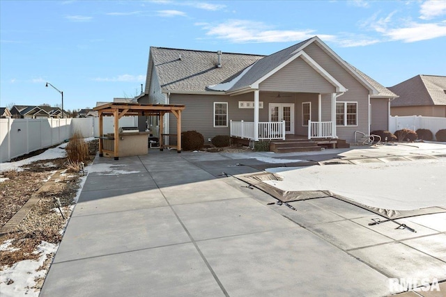 view of front facade with a hot tub and a patio