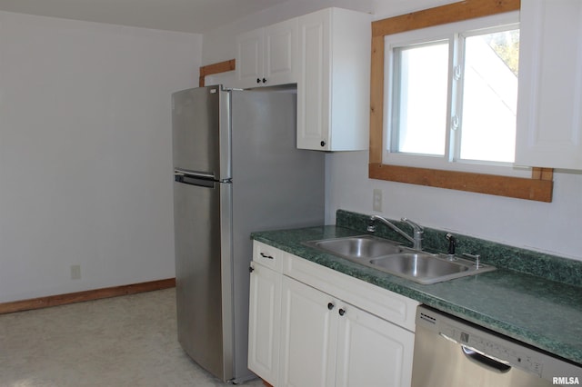 kitchen with sink, white cabinets, and appliances with stainless steel finishes