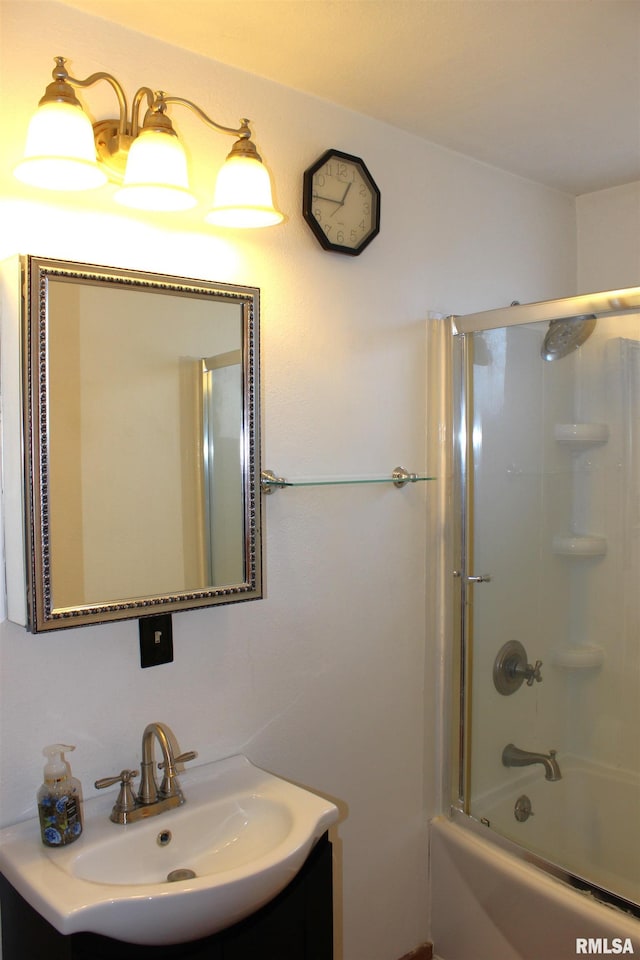 bathroom with vanity and combined bath / shower with glass door