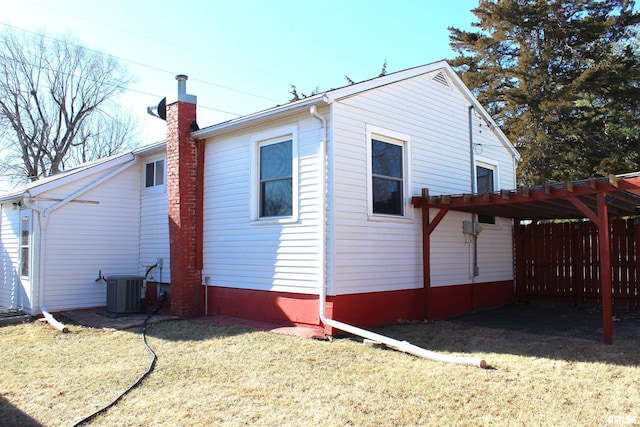 view of property exterior with central AC, a pergola, and a lawn