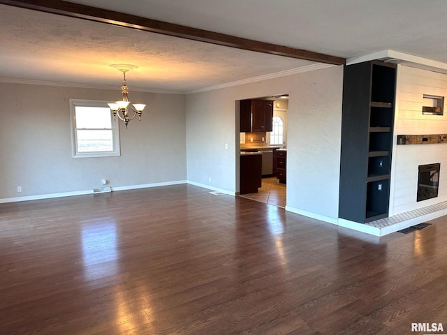 unfurnished living room with crown molding, a notable chandelier, a large fireplace, a textured ceiling, and dark hardwood / wood-style flooring