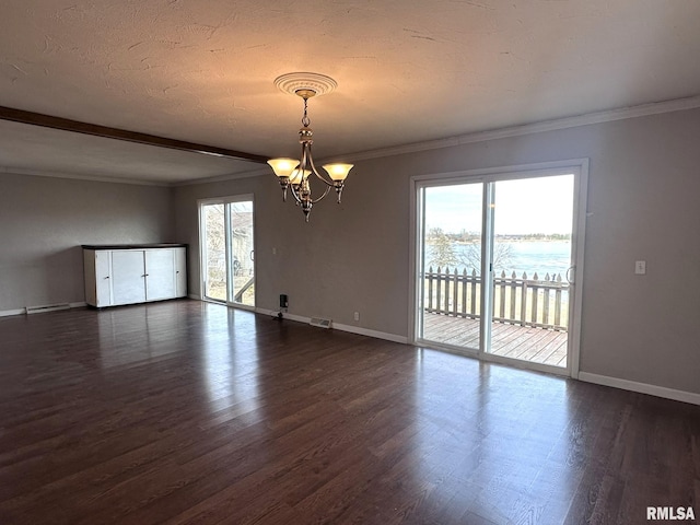 spare room with crown molding, a water view, a healthy amount of sunlight, and a notable chandelier