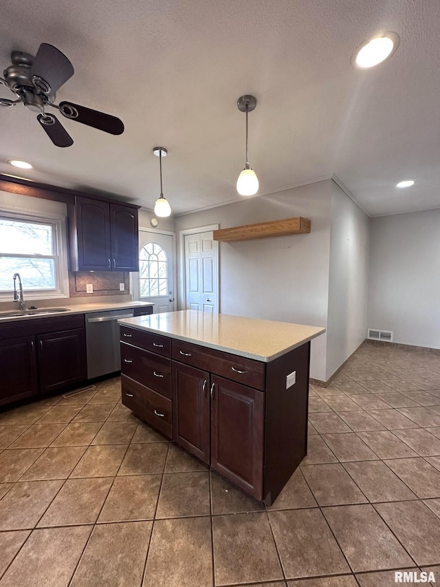 kitchen with decorative light fixtures, sink, stainless steel dishwasher, dark brown cabinets, and tile patterned floors