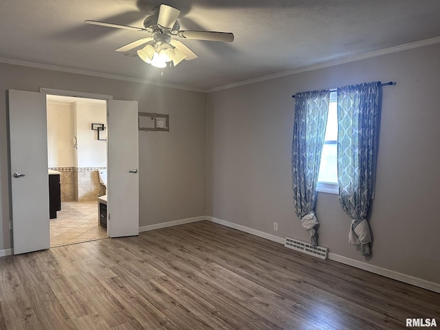 unfurnished bedroom with crown molding, ceiling fan, and hardwood / wood-style floors