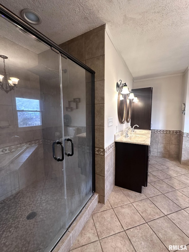 bathroom featuring vanity, tile walls, and a textured ceiling