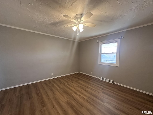 spare room with a textured ceiling, ornamental molding, dark hardwood / wood-style floors, and ceiling fan